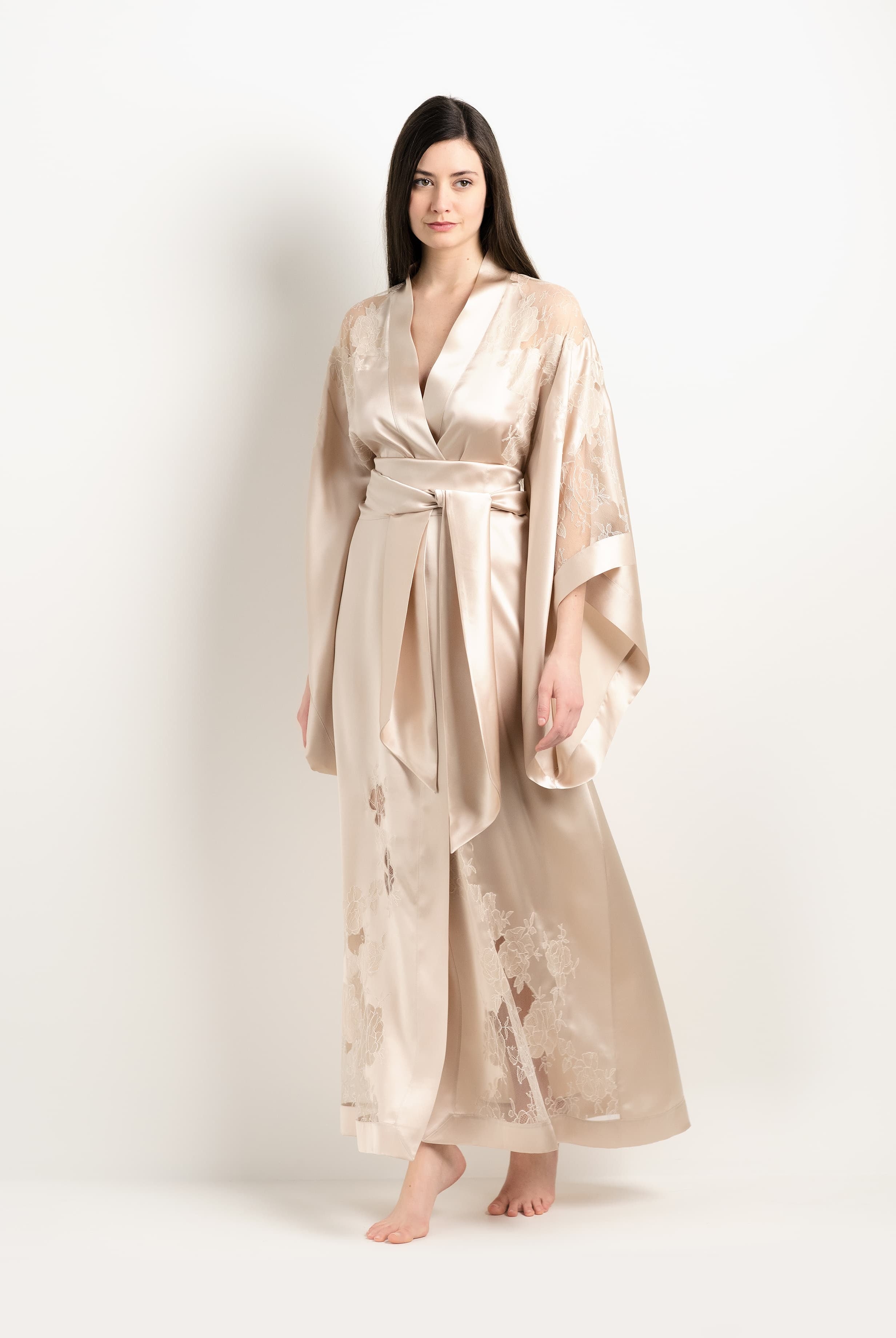 Discover the unique craftmanship of the belgian designer Carine Gilson in her atelier for the 2025 Winter collection with this Long Kimono Butterfly Sleeves in sand beige Silk with ivory lace