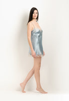 Discover the unique craftmanship of the belgian designer Carine Gilson in her atelier for the 2025 Winter collection with this Slip Babydoll Style V Neckline in Frozen blue Silk  with ivory lace