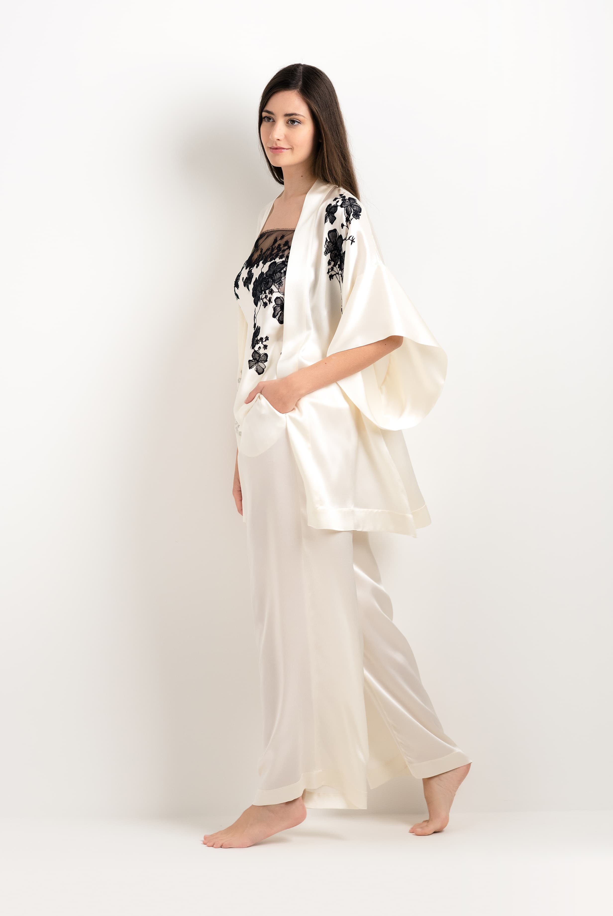 Discover the unique craftmanship of the belgian designer Carine Gilson in her atelier for the 2025 cruise collection with this Short Kimono in Pearl Silk with Black lace