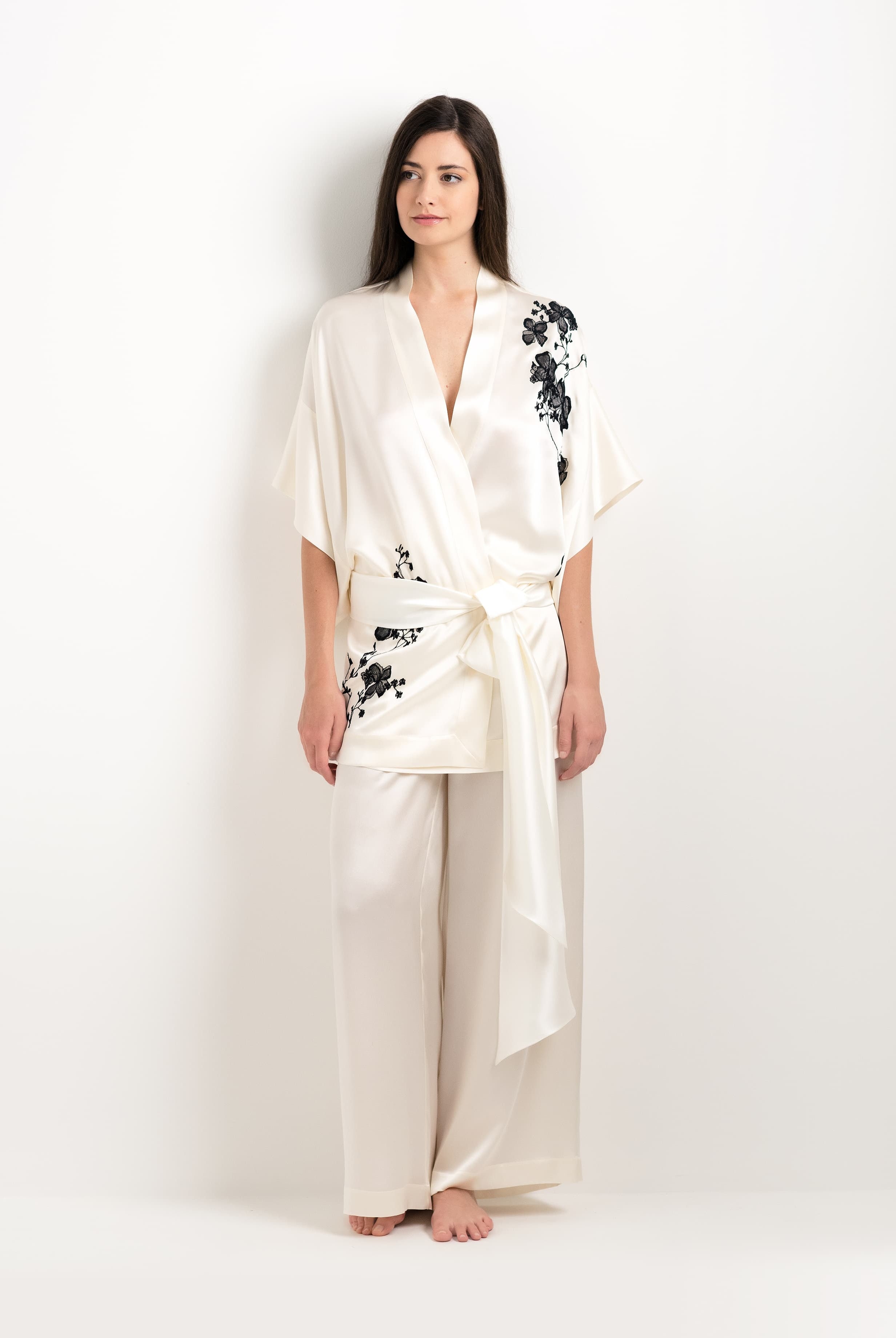 Discover the unique craftmanship of the belgian designer Carine Gilson in her atelier for the 2025 cruise collection with this Short Kimono in Pearl Silk with Black lace