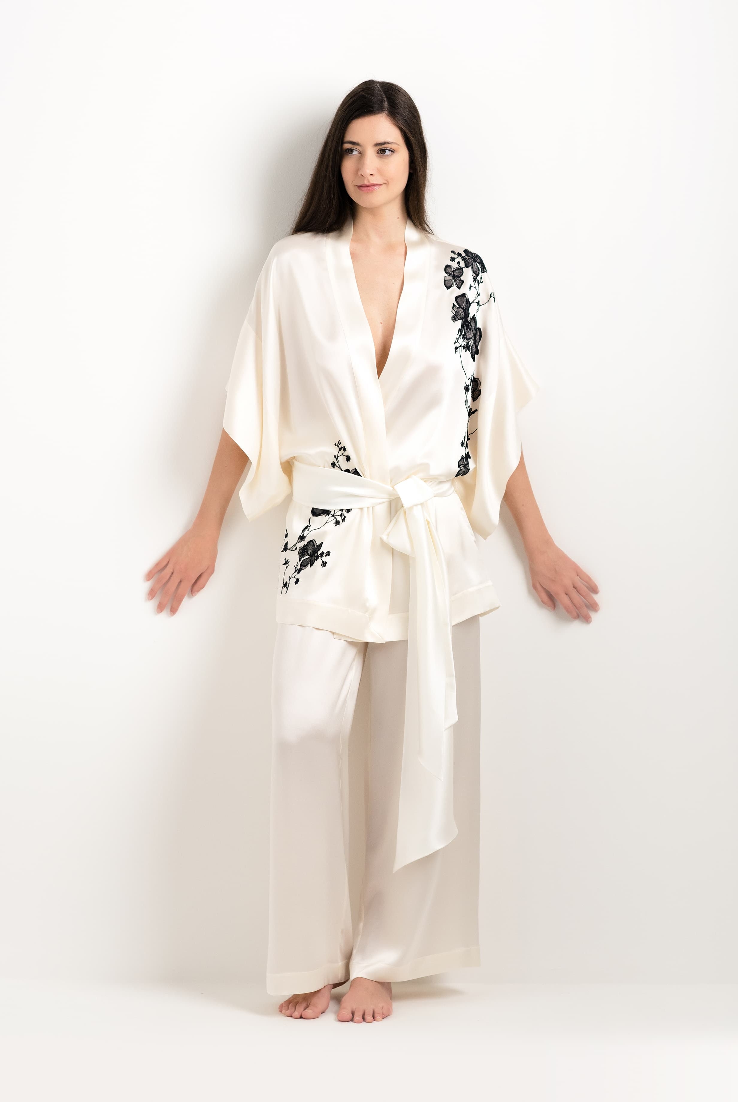 Discover the unique craftmanship of the belgian designer Carine Gilson in her atelier for the 2025 cruise collection with this Short Kimono in Pearl Silk with Black lace