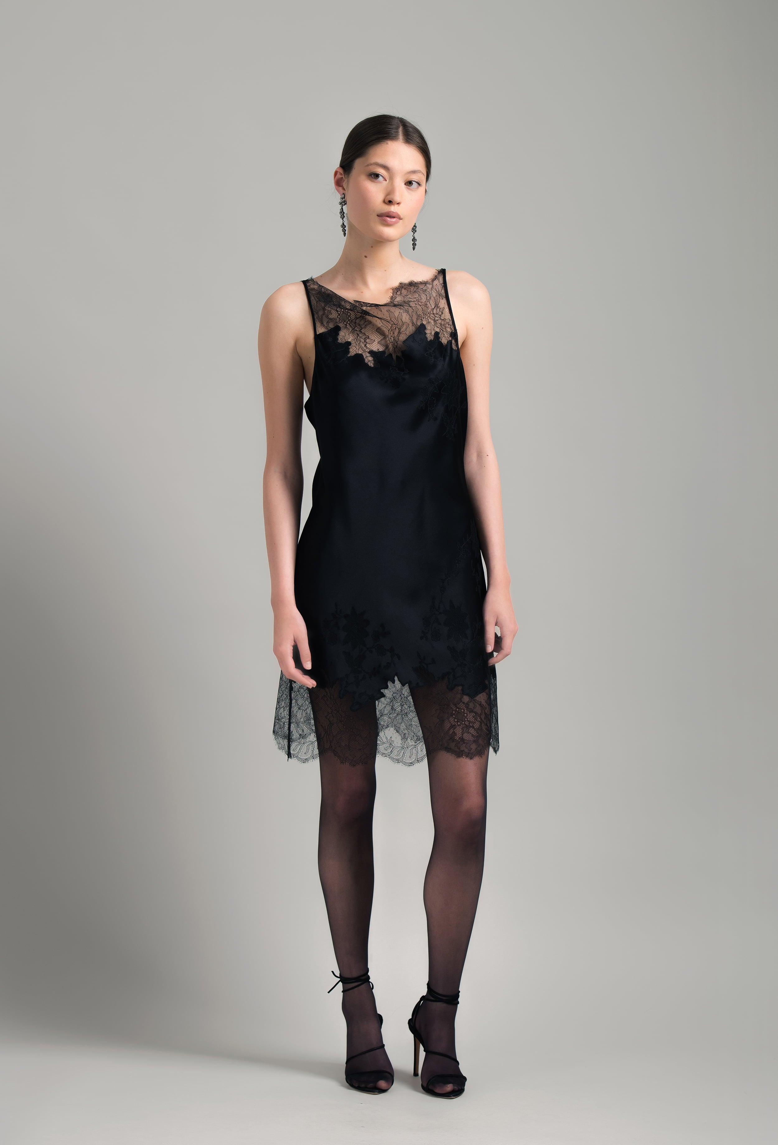 The Winter 2026-27 collection from the house Carine Gilson - The most beautiful couture lingerie to be discovered with this Midi dress with Cowl Neckline with lace in Black Silk with Black lace