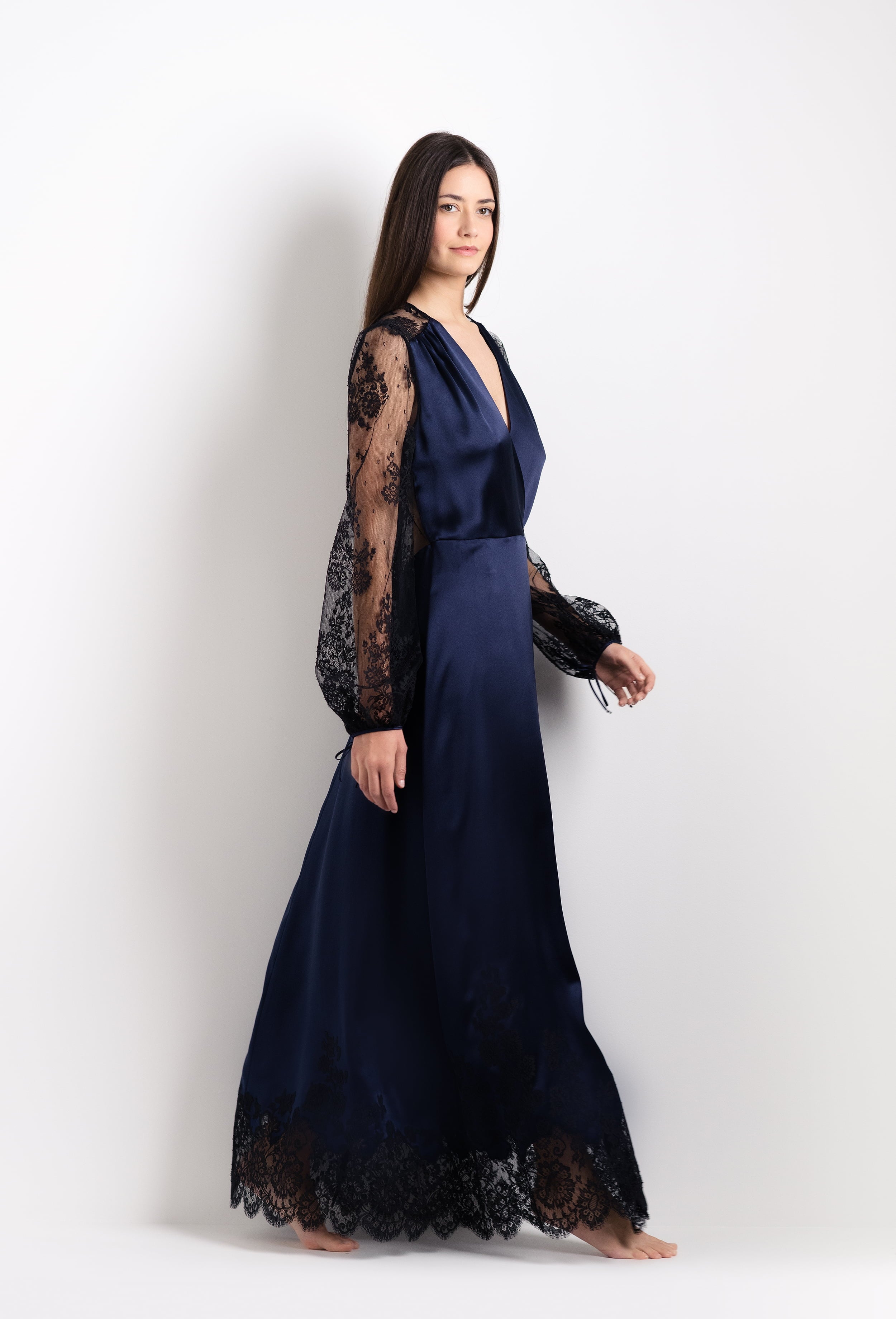 Discover the unique craftmanship of the belgian designer Carine Gilson in her atelier for the 2026 Cruise collection with this Long Déshabillé Cache-Coeur Style Silk Satin in Dark Marine Blue Silk with black lace