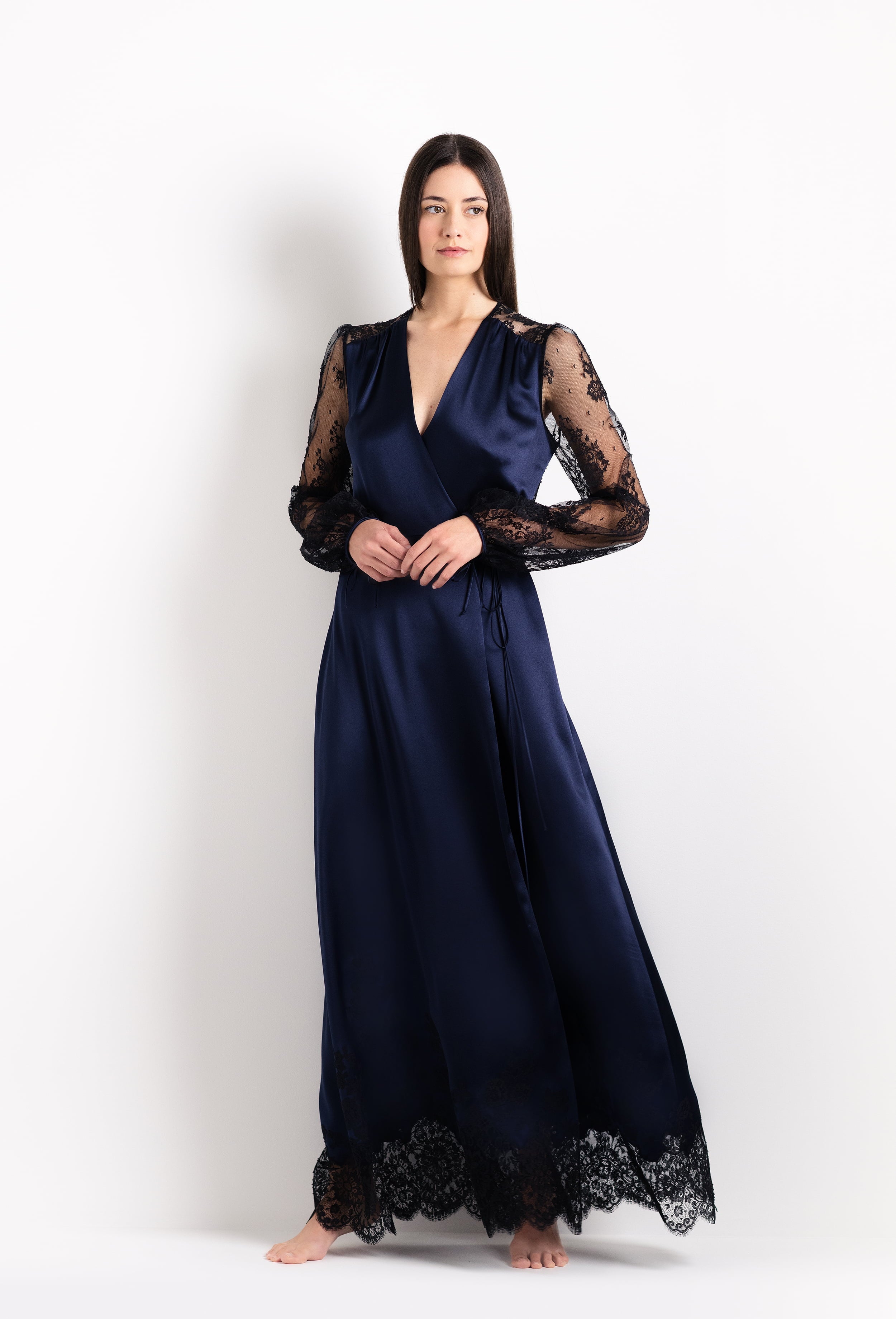 Discover the unique craftmanship of the belgian designer Carine Gilson in her atelier for the 2026 Cruise collection with this Long Déshabillé Cache-Coeur Style Silk Satin in Dark Marine Blue Silk with black lace