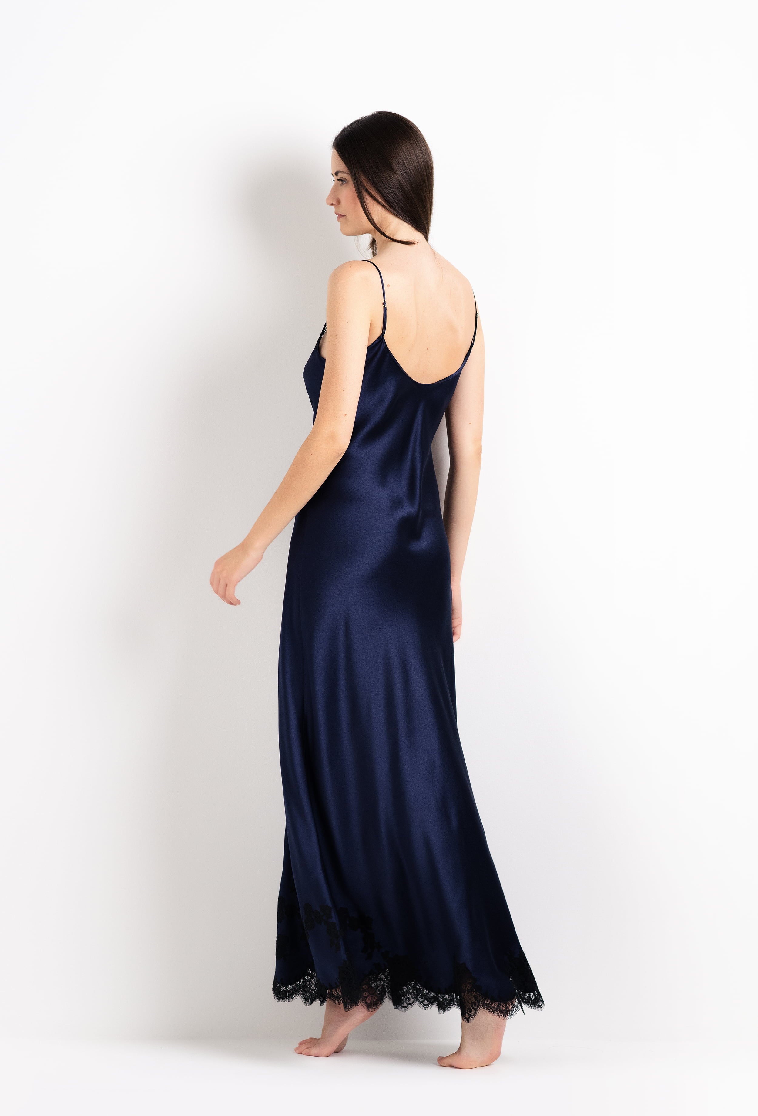 Made of silk and lace, explore the 2026 Cruise collection from the house Carine Gilson with this Long Gown V Neckline in Dark Marine Blue Silk with black lace