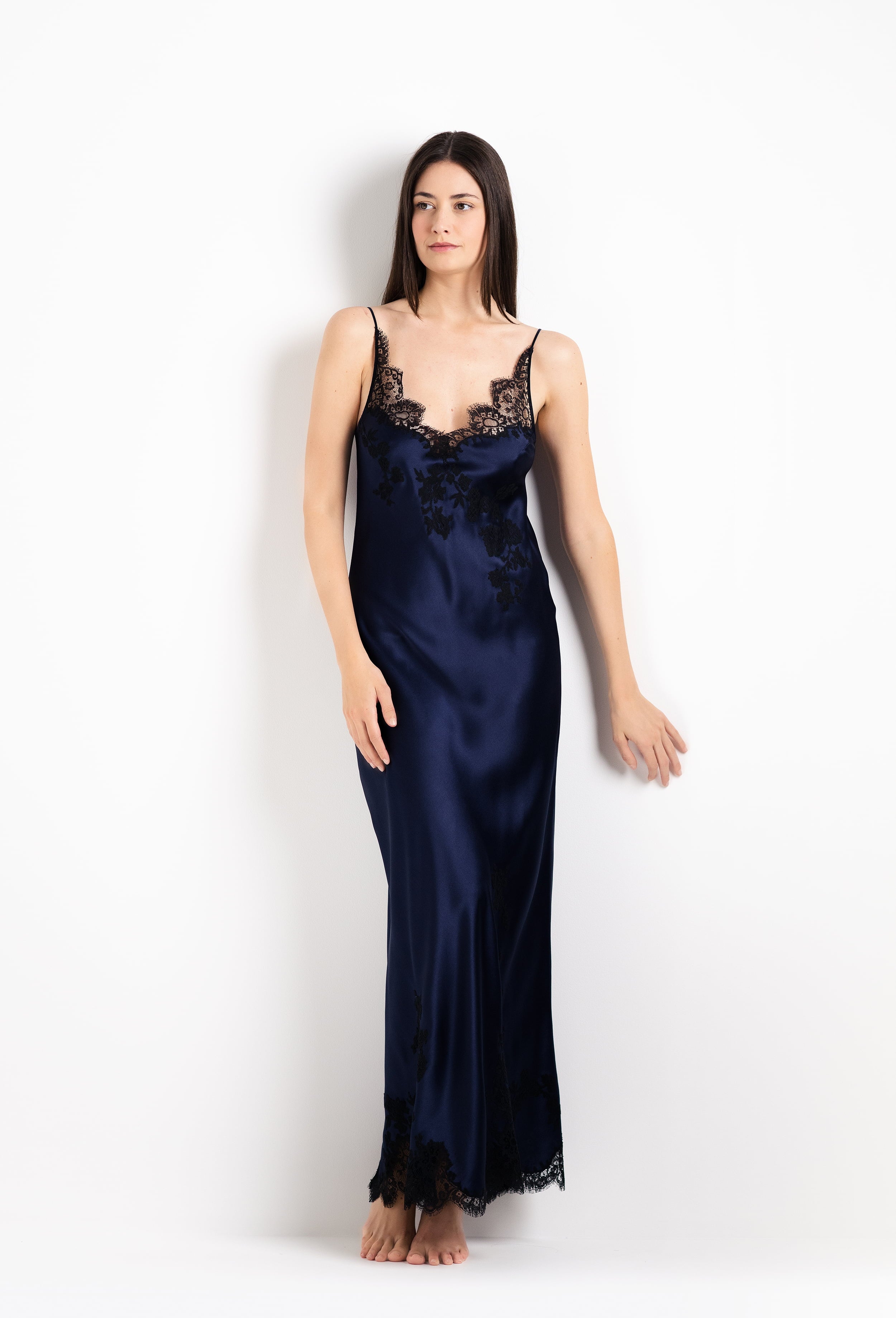 Made of silk and lace, explore the 2026 Cruise collection from the house Carine Gilson with this Long Gown V Neckline in Dark Marine Blue Silk with black lace