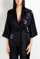 Discover the unique craftmanship of the belgian designer Carine Gilson in her atelier for the 2026 Cruise collection with this Short Kimono Raglan Style in black Silk  with Sparkling black lace