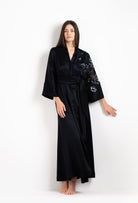 Woman wearing a black kimono-style robe with floral embroidery - Silk and lace