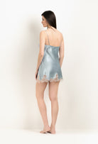 Discover the unique craftmanship of the belgian designer Carine Gilson in her atelier for the 2025 Winter collection with this Slip Babydoll Style V Neckline in Frozen blue Silk  with ivory lace