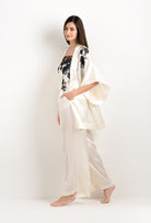 Discover the unique craftmanship of the belgian designer Carine Gilson in her atelier for the 2025 cruise collection with this Short Kimono in Pearl Silk  with Black lace