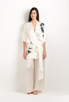 Discover the unique craftmanship of the belgian designer Carine Gilson in her atelier for the 2025 cruise collection with this Short Kimono in Pearl Silk  with Black lace