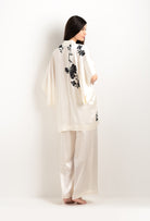 Discover the unique craftmanship of the belgian designer Carine Gilson in her atelier for the 2025 cruise collection with this Short Kimono in Pearl Silk  with Black lace