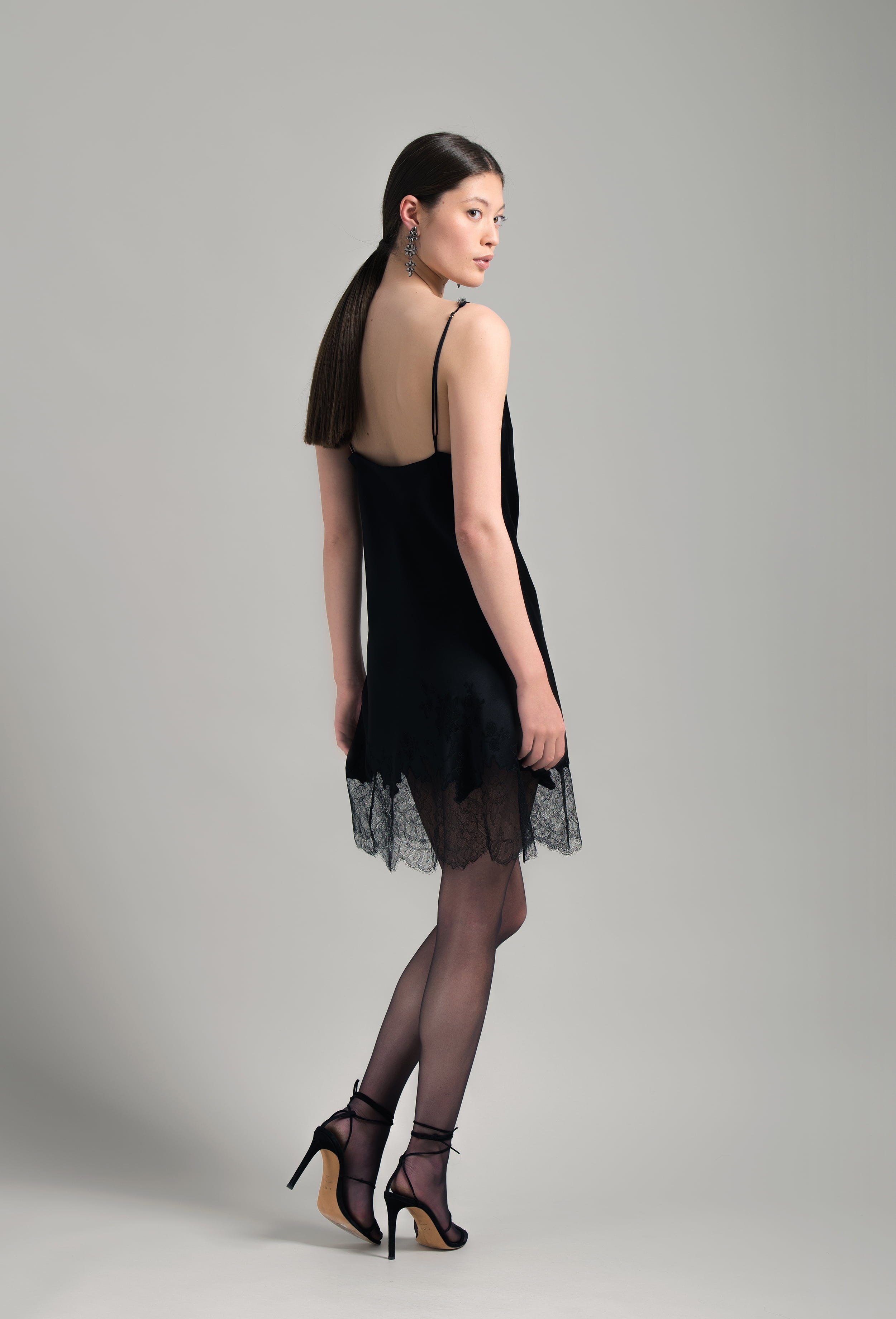 The Winter 2026-27 collection from the house Carine Gilson - The most beautiful couture lingerie to be discovered with this Midi dress with Cowl Neckline with lace in Black Silk  with Black lace