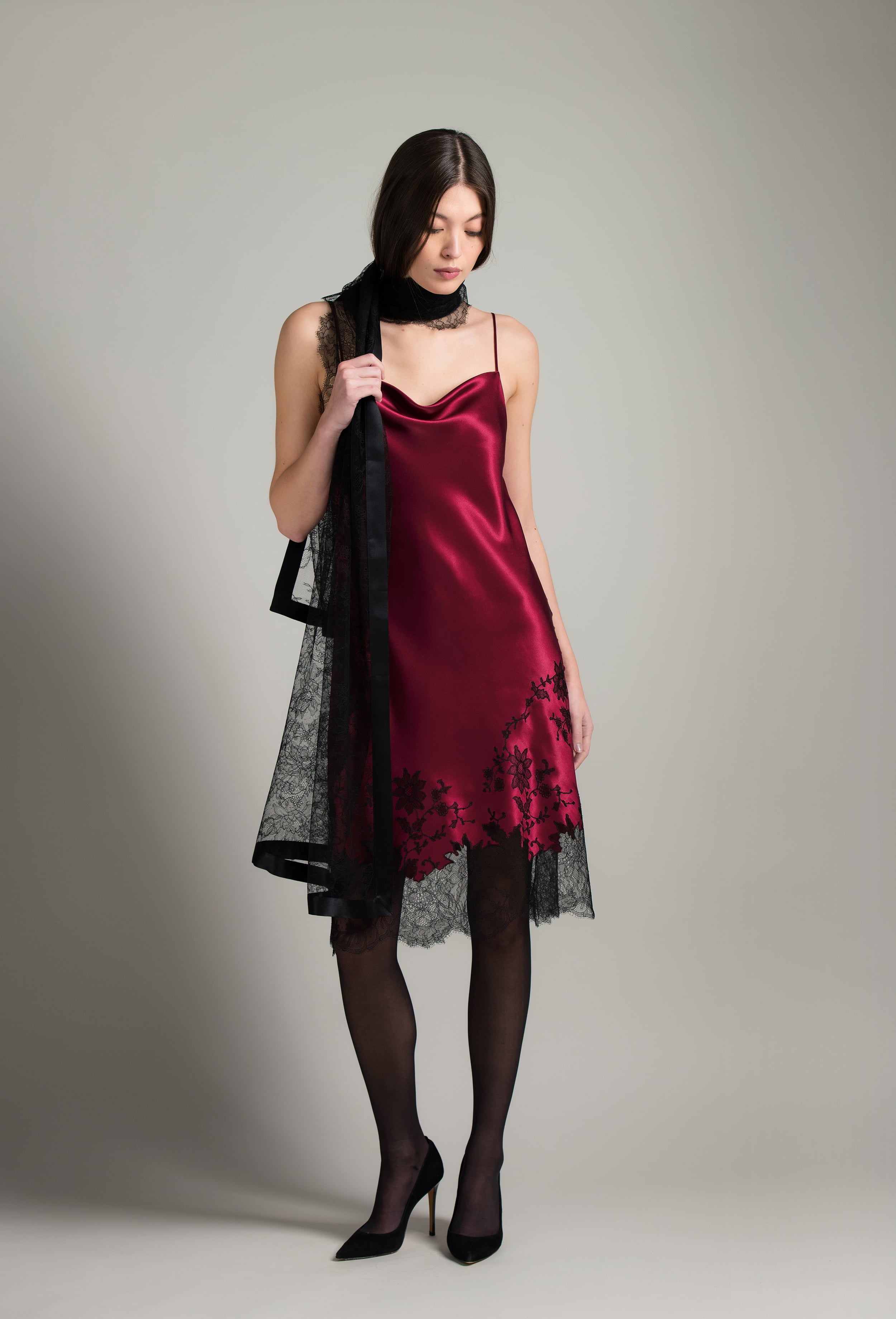 Discover the unique craftmanship of the belgian designer Carine Gilson in her atelier for the Winter 2026-27 collection with this Midi Dress with Scoop Neckline in Rubis red Silk  with Black lace