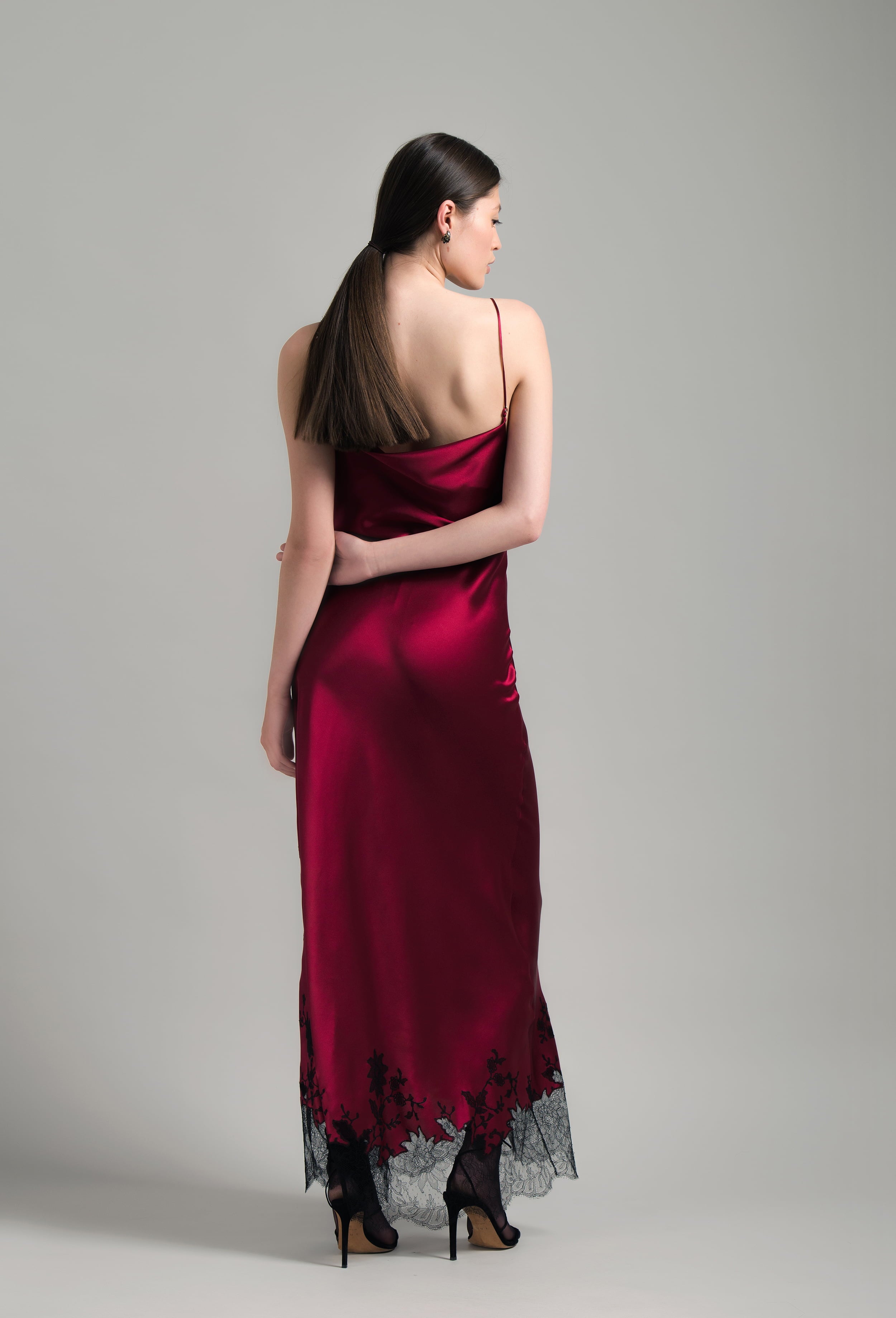 The Winter 2026-27 collection from the house Carine Gilson - The most beautiful couture lingerie to be discovered with this Long Dress Cowl Neckline with lace in Rubis red Silk  with Black lace