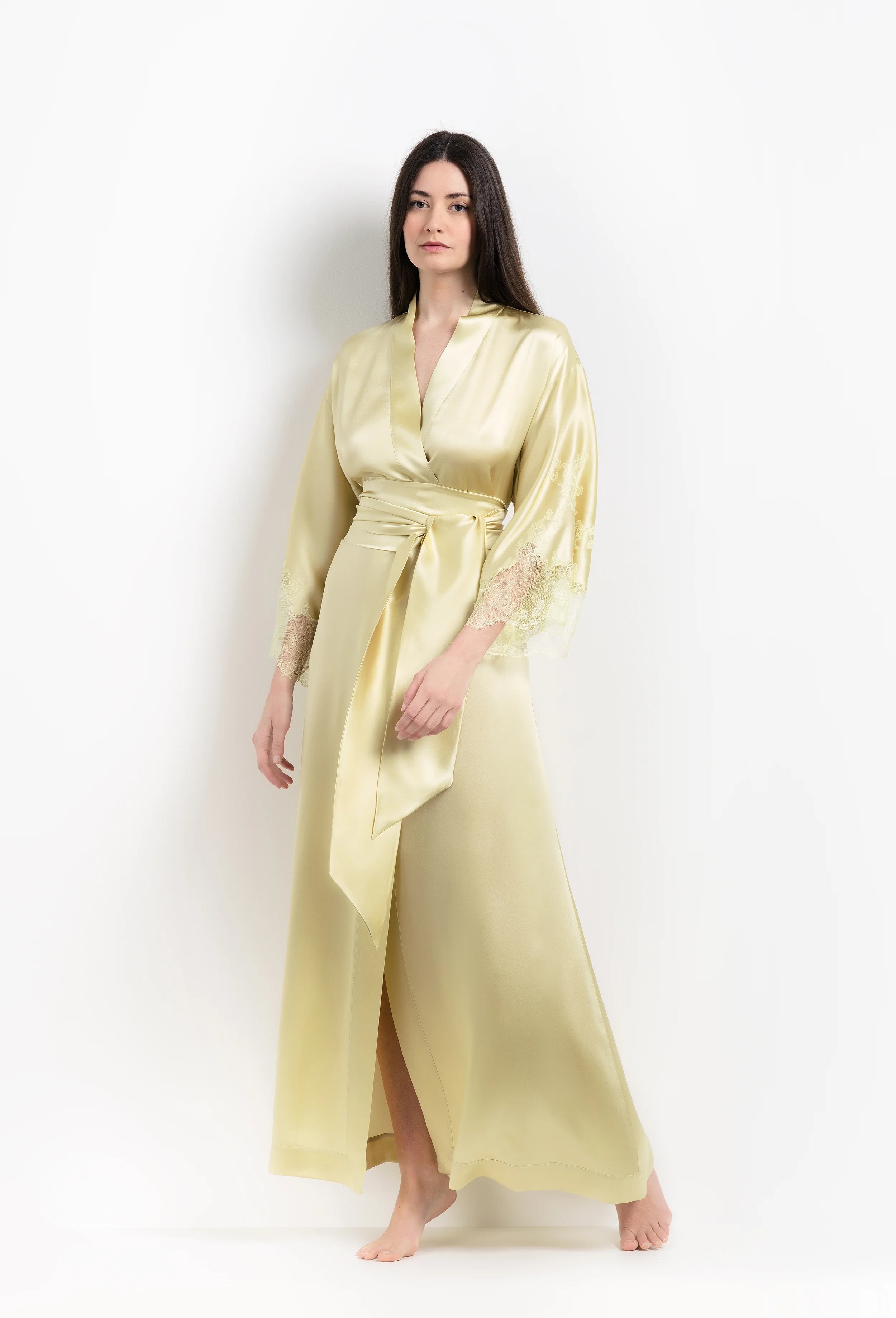 Discover the unique craftmanship of the belgian designer Carine Gilson in her atelier for the 2026 Summer collection with this long kimono classic sleeves in light yellow silk with acid yellow lace