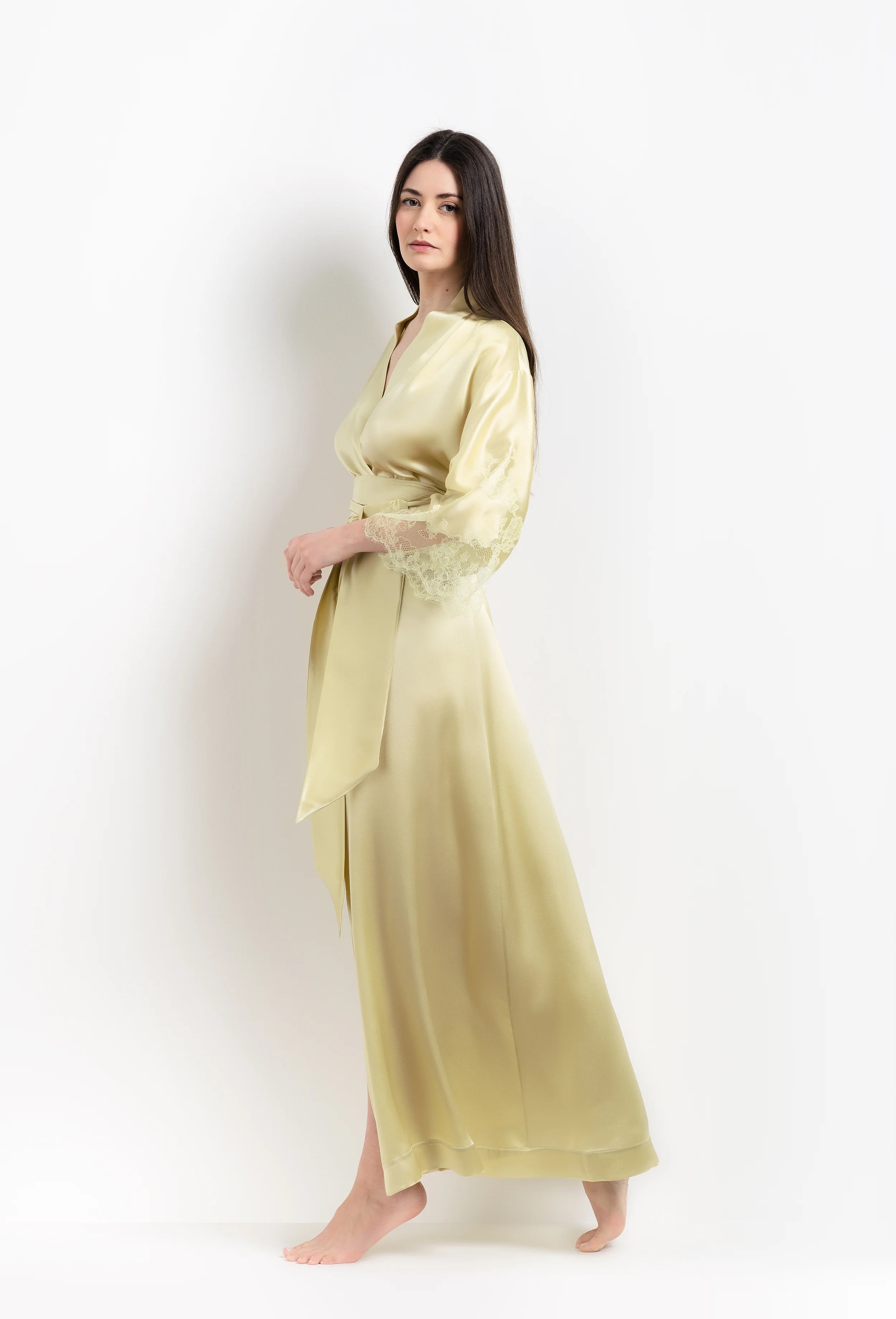 Discover the unique craftmanship of the belgian designer Carine Gilson in her atelier for the 2026 Summer collection with this long kimono classic sleeves in light yellow silk with acid yellow lace