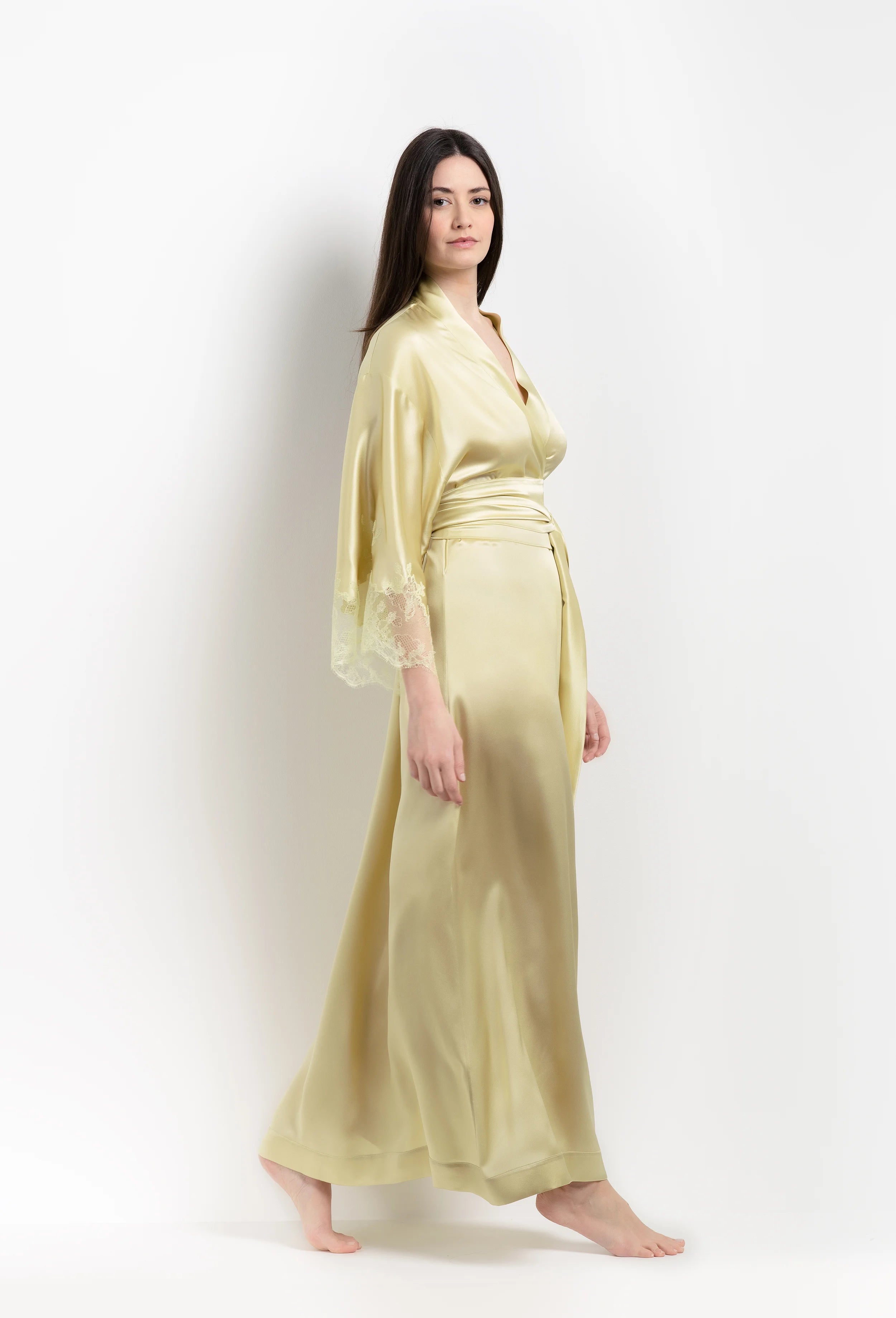 Discover the unique craftmanship of the belgian designer Carine Gilson in her atelier for the 2026 Summer collection with this long kimono classic sleeves in light yellow silk with acid yellow lace