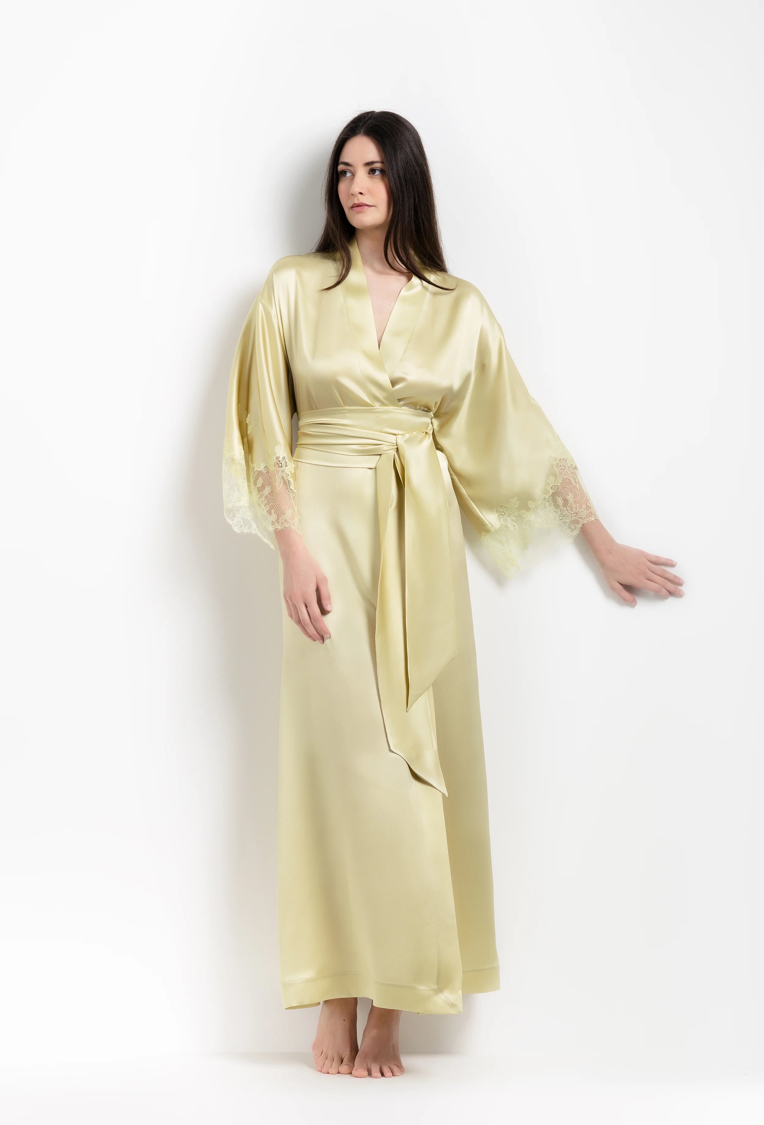 Discover the unique craftmanship of the belgian designer Carine Gilson in her atelier for the 2026 Summer collection with this long kimono classic sleeves in light yellow silk with acid yellow lace