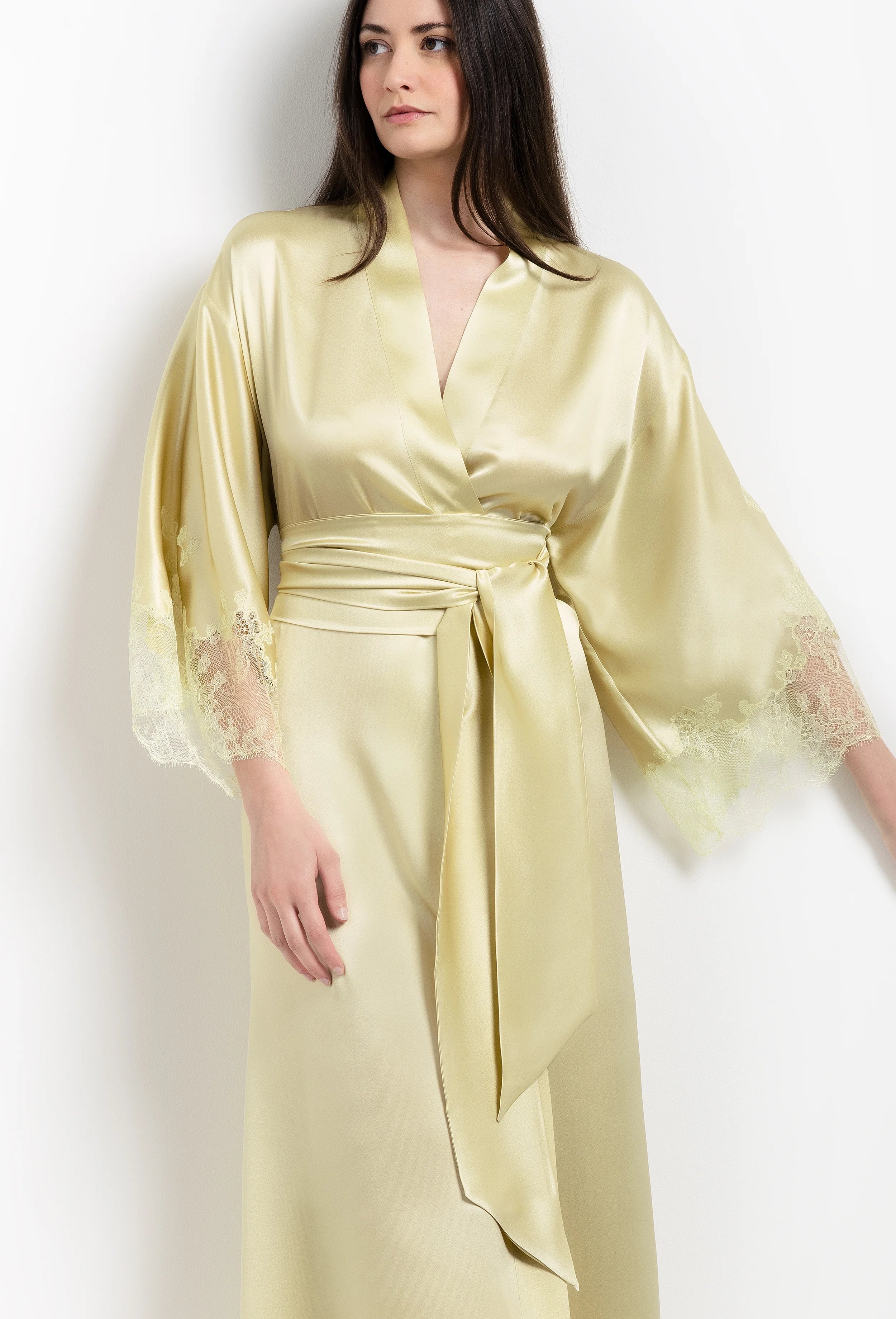 Discover the unique craftmanship of the belgian designer Carine Gilson in her atelier for the 2026 Summer collection with this long kimono classic sleeves in light yellow silk with acid yellow lace