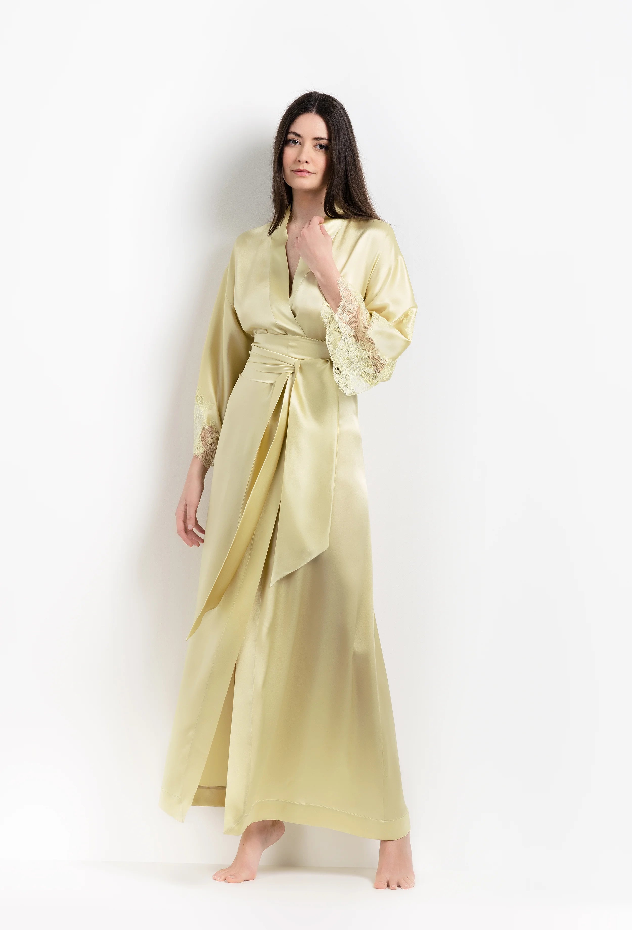 Discover the unique craftmanship of the belgian designer Carine Gilson in her atelier for the 2026 Summer collection with this long kimono classic sleeves in light yellow silk with acid yellow lace