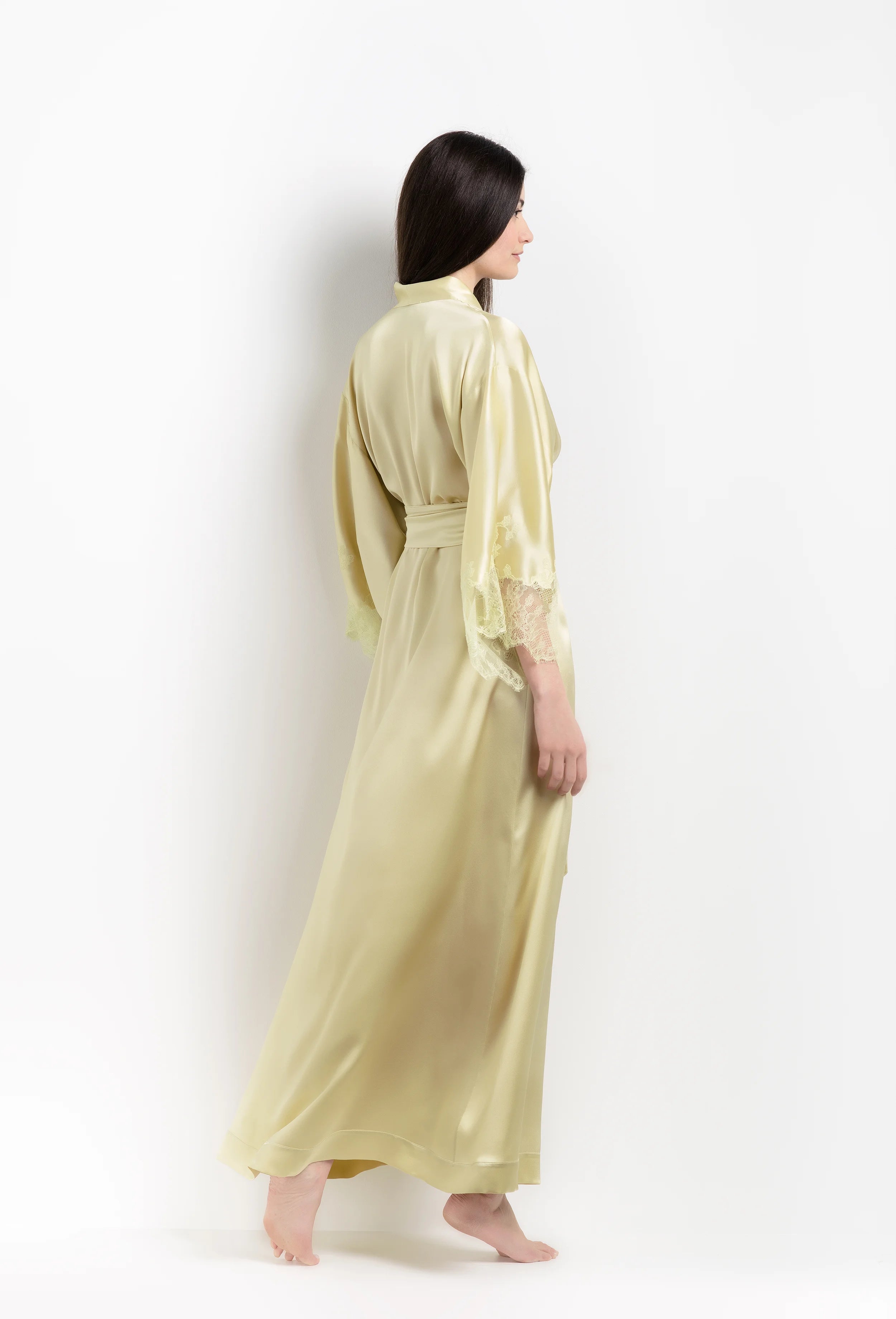 Discover the unique craftmanship of the belgian designer Carine Gilson in her atelier for the 2026 Summer collection with this long kimono classic sleeves in light yellow silk with acid yellow lace