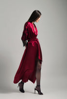 Discover the unique craftmanship of the belgian designer Carine Gilson in her atelier for the Winter 2026-27 collection with this Long Kimono Raglan Style in Rubis red Silk  with Black lace