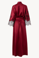 Discover the unique craftmanship of the belgian designer Carine Gilson in her atelier for the Winter 2026-27 collection with this Long Kimono Raglan Style in Rubis red Silk  with Black lace