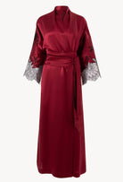 Discover the unique craftmanship of the belgian designer Carine Gilson in her atelier for the Winter 2026-27 collection with this Long Kimono Raglan Style in Rubis red Silk  with Black lace