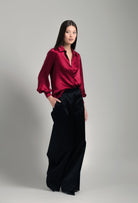 Discover the unique craftmanship of the belgian designer Carine Gilson in her atelier for the Winter 2026-27 collection with this Shirt With Balloon Sleeves in Rubis red Silk 