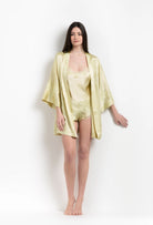 Enjoy the 2026 Summer collection of lingerie couture from the house Carine Gilson with this short kimono classic sleeves in light yellow silk with acid yellow lace