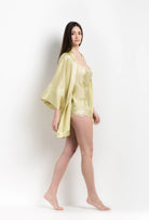 Enjoy the 2026 Summer collection of lingerie couture from the house Carine Gilson with this short kimono classic sleeves in light yellow silk with acid yellow lace