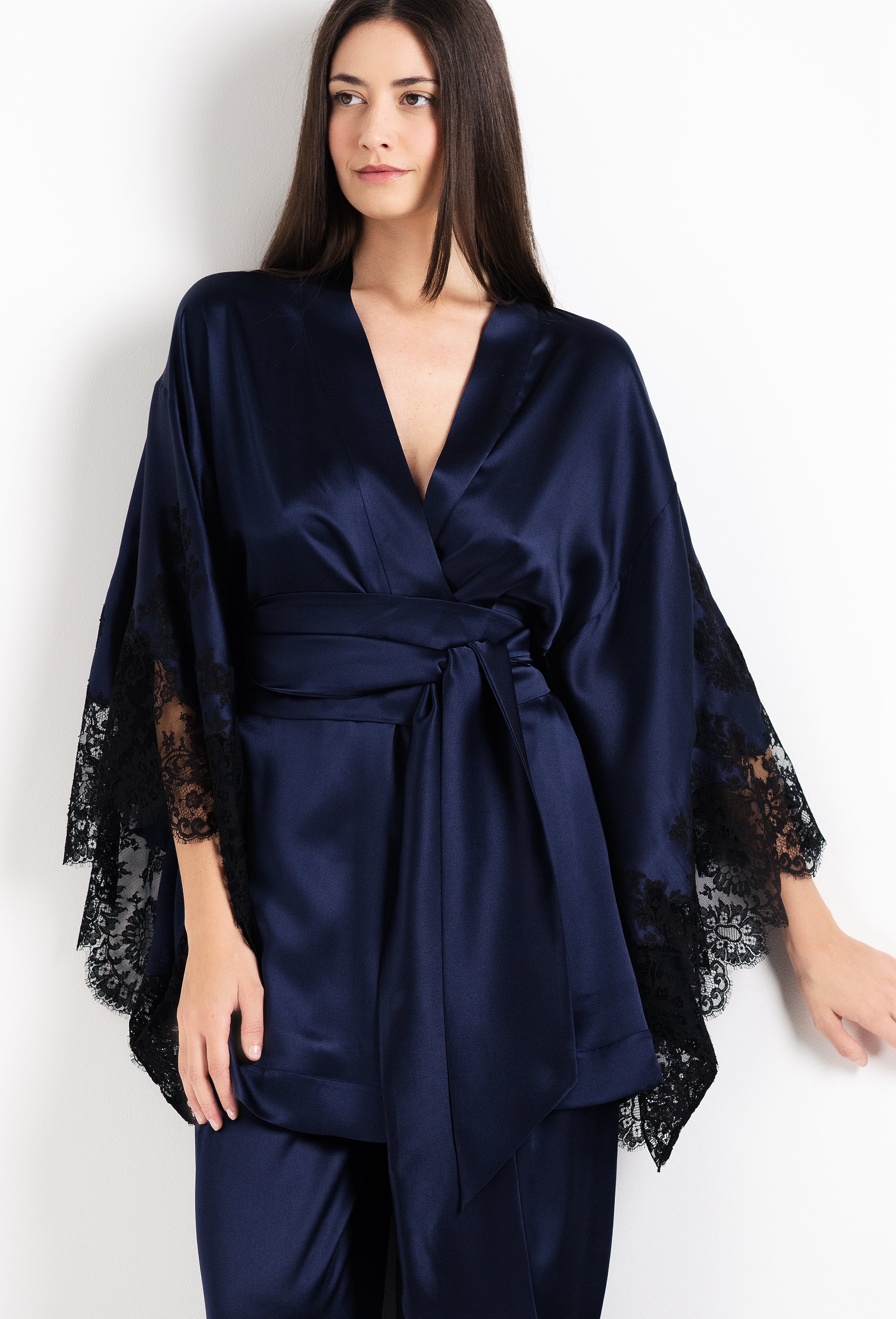 Navy blue satin robe with lace sleeves on a white background