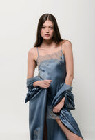 The Hiver 2026-27 collection from the house Carine Gilson - The most beautiful couture lingerie to be discovered with this babydoll style straight neckline in blue stone silk  with grey lace