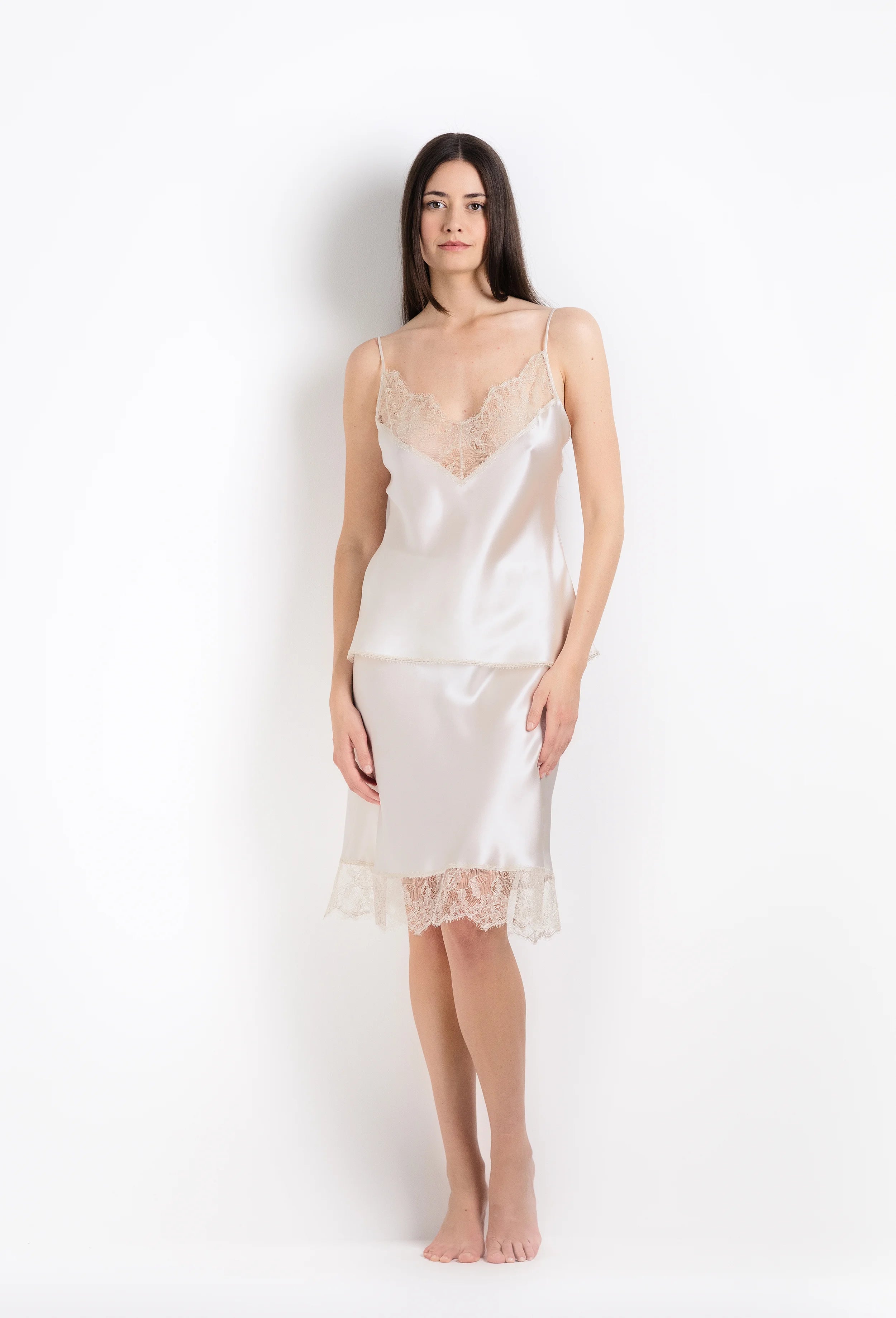 Discover the unique craftmanship of the belgian designer Carine Gilson in her atelier for the 2026 Summer collection with this camisole classic in ivory silk  with ivory lace