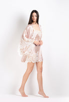 Discover the 2026 Cruise collection of lingerie couture from the house Carine Gilson with this short kimono butterfly sleeves in silverpink silk  with natural lace