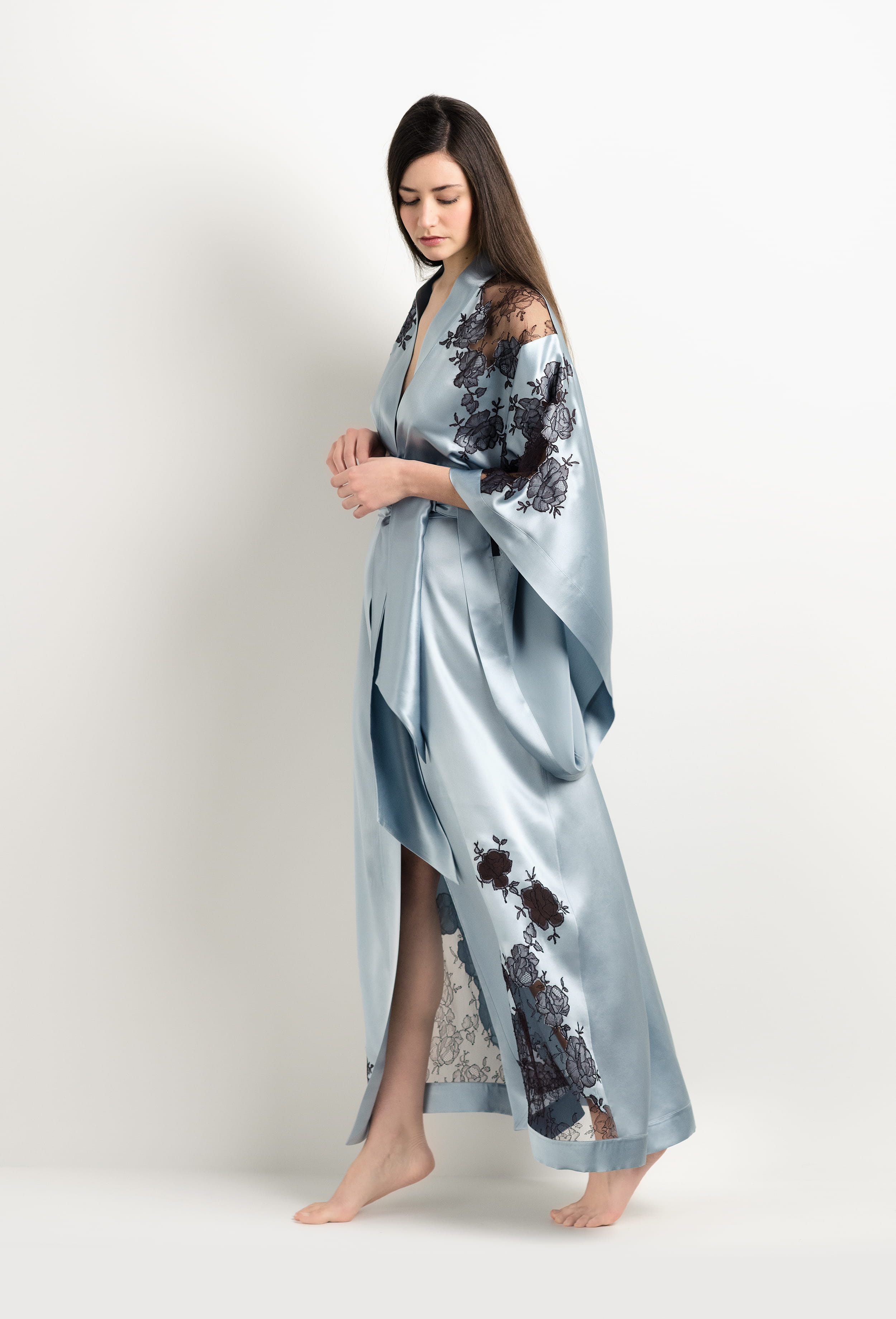Discover the unique craftmanship of the belgian designer Carine Gilson in her atelier for the 2025 Winter collection with this Long Kimono Butterfly Sleeves in Frozen blue Silk  with Ebony lace