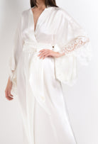 Discover the unique craftmanship of the belgian designer Carine Gilson in her atelier for the 2026 Cruise collection with this long kimono butterfly sleeves in natural silk  with natural lace
