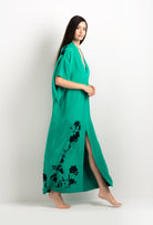 Discover the unique craftmanship of the belgian designer Carine Gilson in her atelier for the 2025 cruise collection with this Long V Neck Kaftan in Jade Green Silk  with Black lace