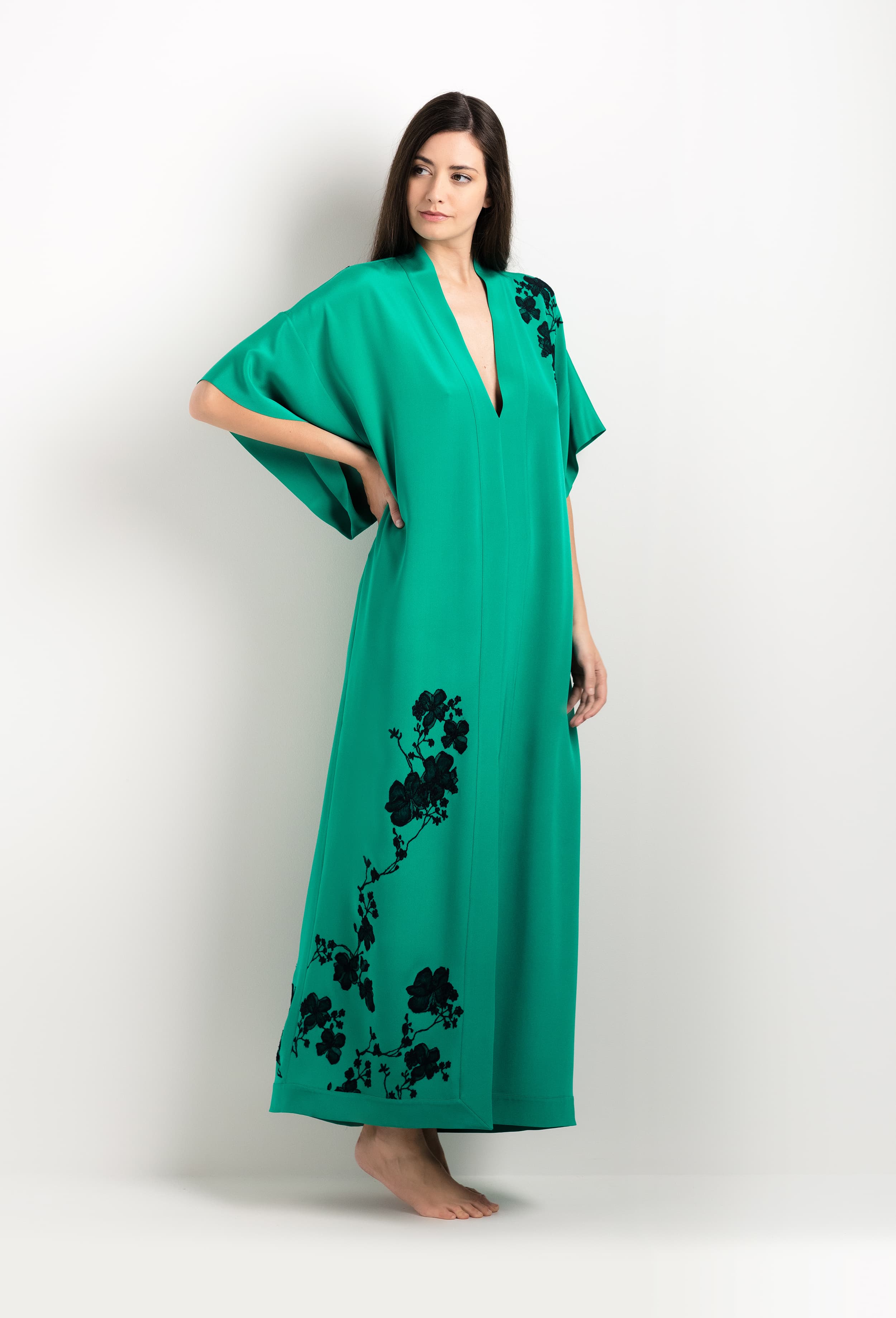 Discover the unique craftmanship of the belgian designer Carine Gilson in her atelier for the 2025 cruise collection with this Long V Neck Kaftan in Jade Green Silk  with Black lace