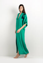 Discover the unique craftmanship of the belgian designer Carine Gilson in her atelier for the 2025 cruise collection with this Long V Neck Kaftan in Jade Green Silk  with Black lace