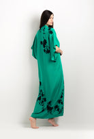 Discover the unique craftmanship of the belgian designer Carine Gilson in her atelier for the 2025 cruise collection with this Long V Neck Kaftan in Jade Green Silk  with Black lace