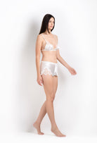 Discover the 2026 Cruise collection of lingerie couture from the house Carine Gilson with this soft triangle bra in natural silk  with natural lace