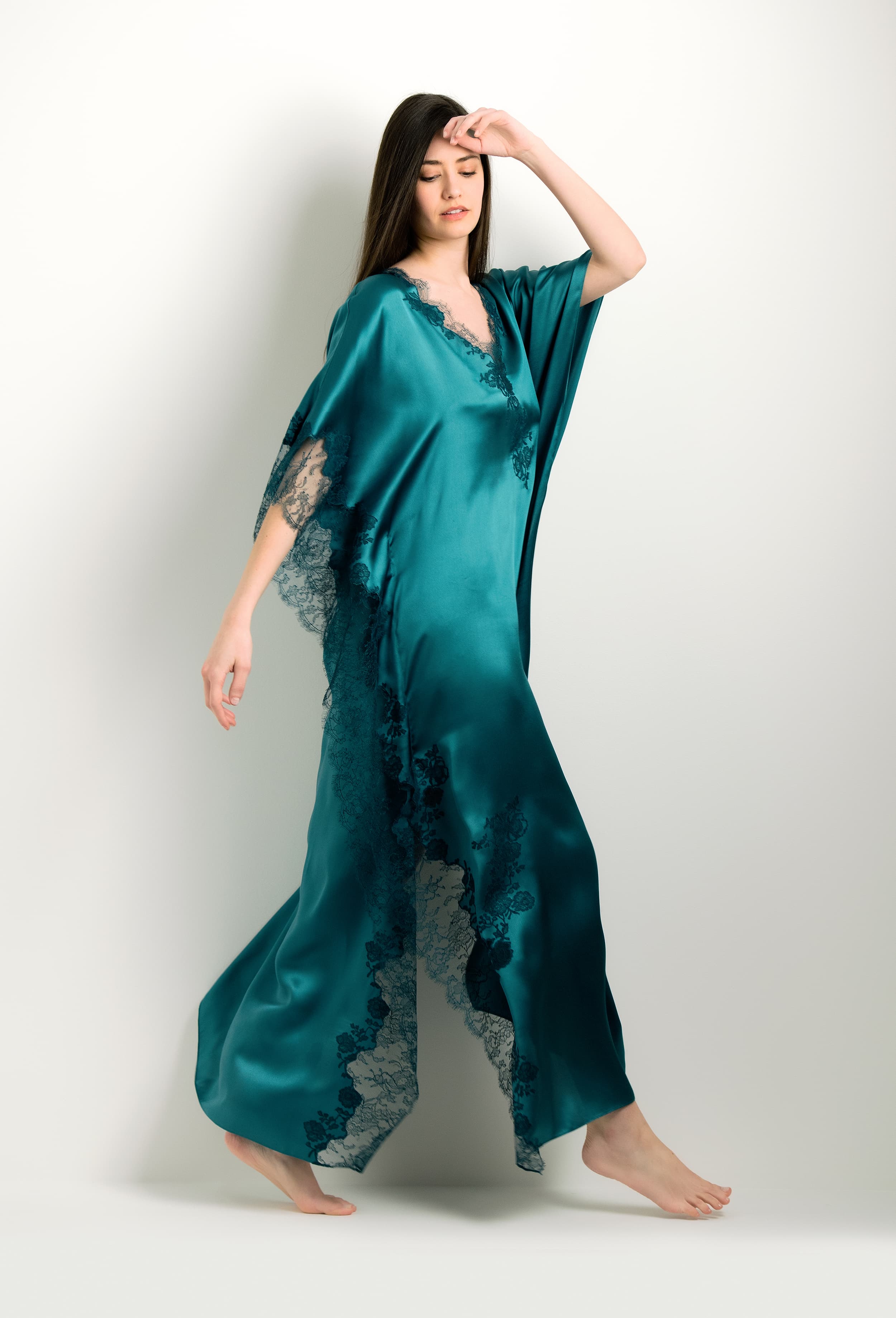 Discover the unique craftmanship of the belgian designer Carine Gilson in her atelier for the 2024 winter collectionLong Kaftan V Neck in blue Silk with emerald green lace