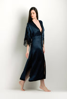 Discover the unique craftmanship of the belgian designer Carine Gilson in her atelier for the 2024 winter collectionLong V Neck Kaftan in dark blue Silk with Black lace