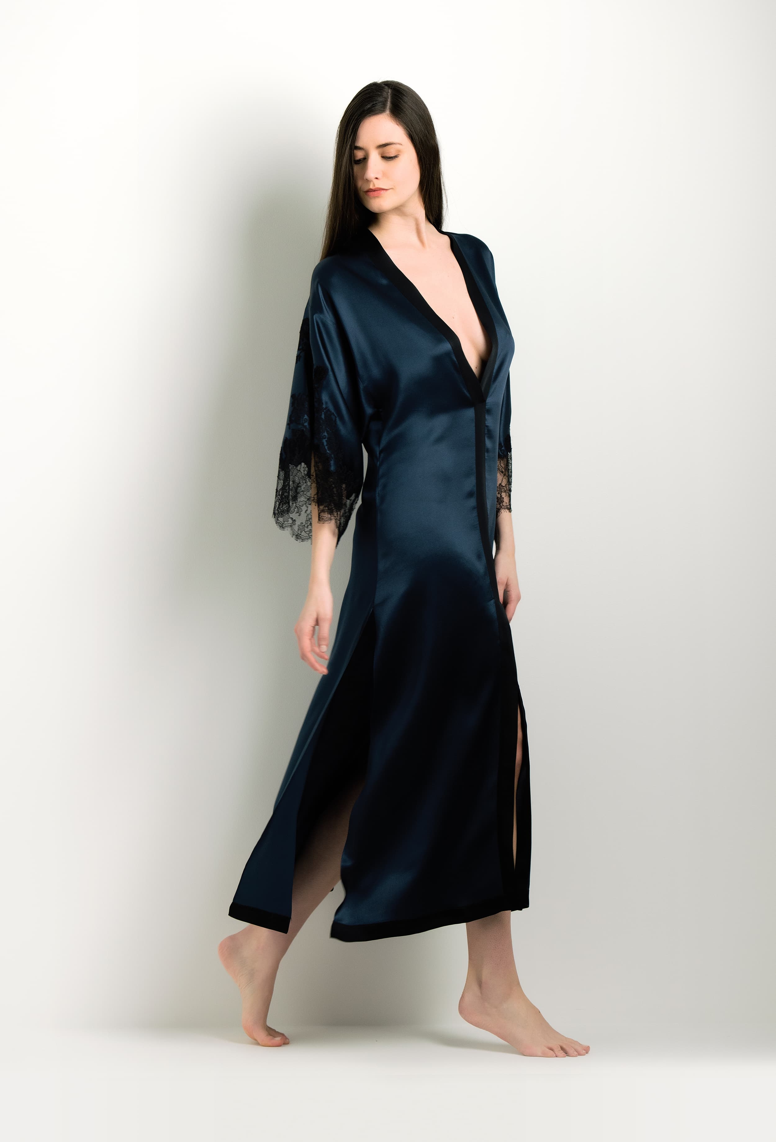 Discover the unique craftmanship of the belgian designer Carine Gilson in her atelier for the 2024 winter collectionLong V Neck Kaftan in dark blue Silk with Black lace