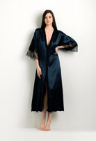 Discover the unique craftmanship of the belgian designer Carine Gilson in her atelier for the 2024 winter collectionLong V Neck Kaftan in dark blue Silk with Black lace