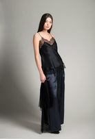 The Winter 2026-27 collection from the house Carine Gilson - The most beautiful couture lingerie to be discovered with this Long Top V Neckline with cuts in black Silk  with black lace