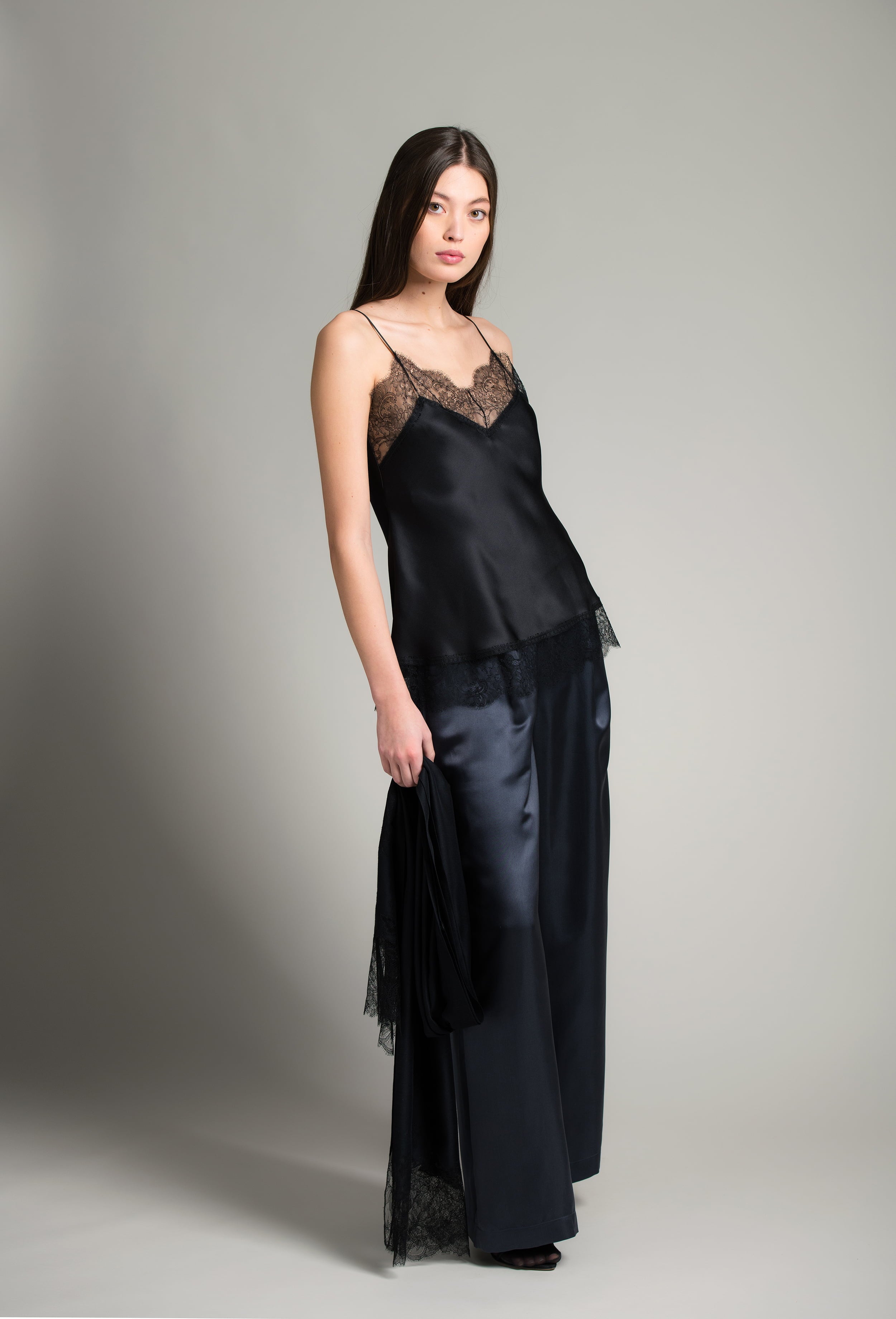 The Winter 2026-27 collection from the house Carine Gilson - The most beautiful couture lingerie to be discovered with this Long Top V Neckline with cuts in black Silk  with black lace