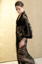 Discover the unique craftmanship of the belgian designer Carine Gilson in her atelier for the 2026 Cruise collection with this Long V Neck Kaftan in black Silk  with black lace